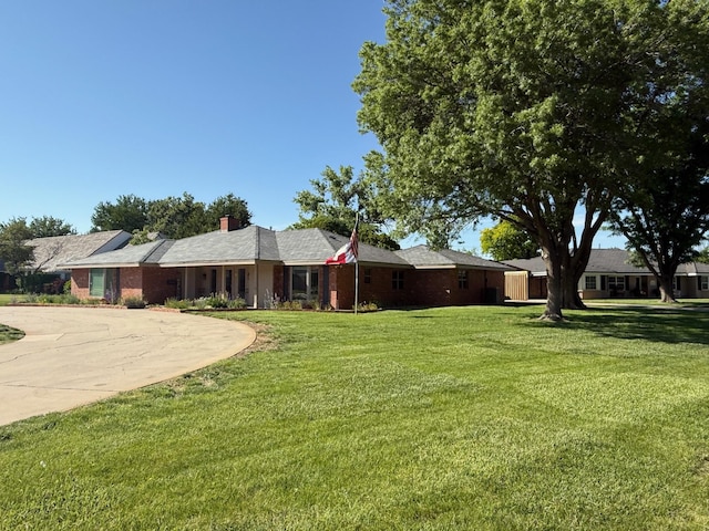 3417 Danbury Dr, Amarillo, TX 79109 - single story home with a front lawn, curved driveway, and a chimney