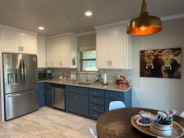 3417 Danbury Dr, Amarillo, TX 79109 - kitchen with stainless steel appliances, a sink, ornamental molding, white cabinetry, and backsplash