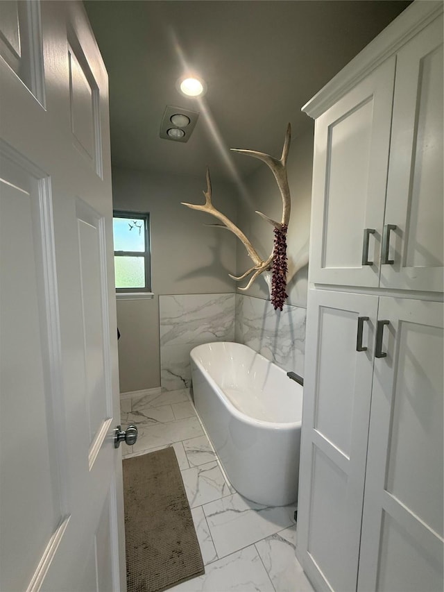 3417 Danbury Dr, Amarillo, TX 79109 - full bath with marble finish flooring, a freestanding bath, wainscoting, and tile walls