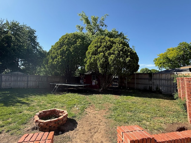 3417 Danbury Dr, Amarillo, TX 79109 - view of yard featuring a trampoline and a fire pit