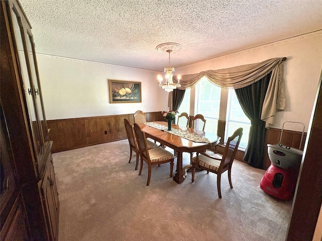 1107 Rock Springs Rd, Duncanville, TX 75137 - carpeted dining area with a chandelier, wainscoting, wooden walls, and a textured ceiling