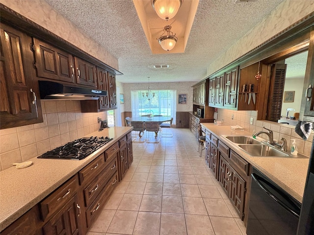 1107 Rock Springs Rd, Duncanville, TX 75137 - kitchen with under cabinet range hood, black appliances, a textured ceiling, light countertops, and dark brown cabinetry