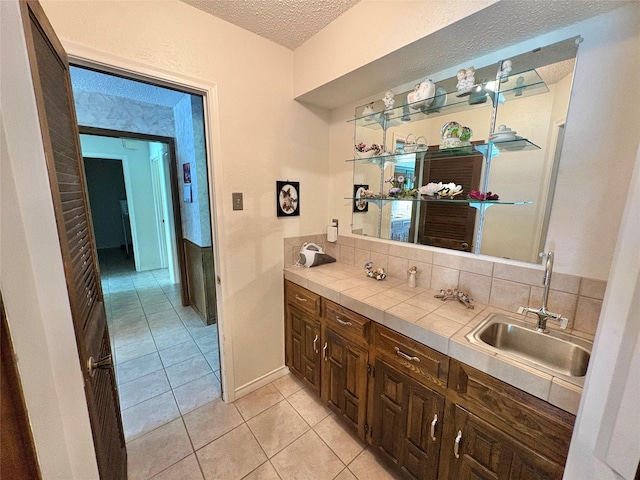 1107 Rock Springs Rd, Duncanville, TX 75137 - bathroom with a textured ceiling, tile patterned flooring, and vanity