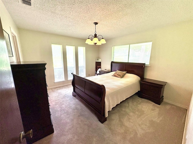 1107 Rock Springs Rd, Duncanville, TX 75137 - carpeted bedroom featuring a chandelier and a textured ceiling