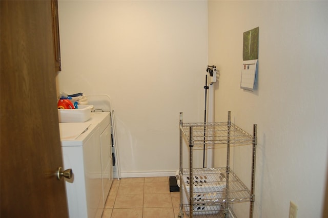 1107 Rock Springs Rd, Duncanville, TX 75137 - laundry room with washing machine and clothes dryer and light tile patterned flooring