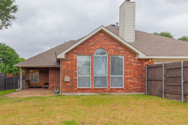 6506 Bunker Hill Ct, Rowlett, TX 75089 - back of property featuring brick siding, roof with shingles, a chimney, and a patio