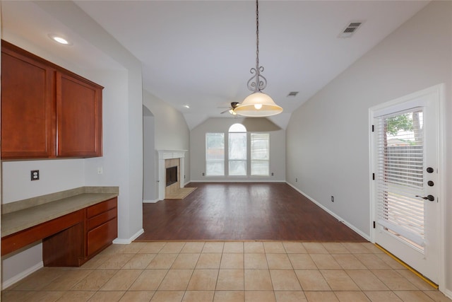 6506 Bunker Hill Ct, Rowlett, TX 75089 - kitchen with ceiling fan, healthy amount of natural light, a fireplace, hanging light fixtures, and lofted ceiling