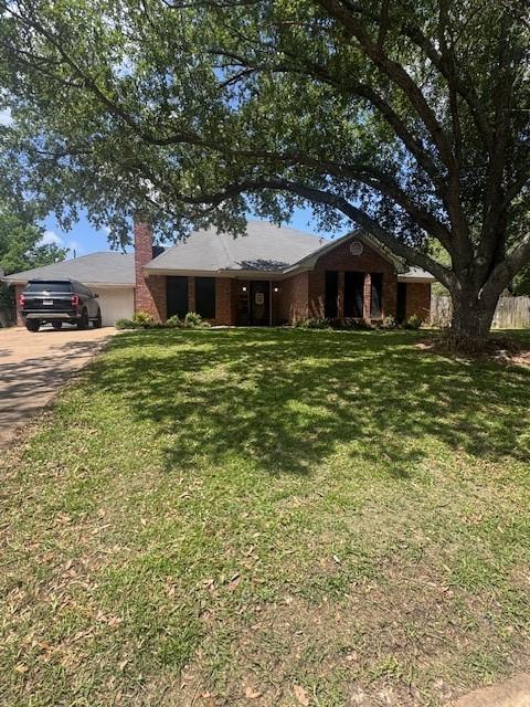226 Colonial Cir, Athens, TX 75751 - ranch-style house with a garage, a chimney, a front yard, and driveway