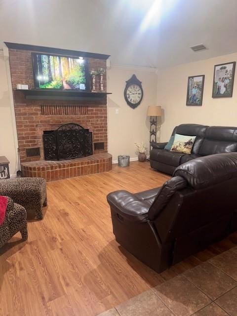226 Colonial Cir, Athens, TX 75751 - living area featuring wood finished floors and a brick fireplace