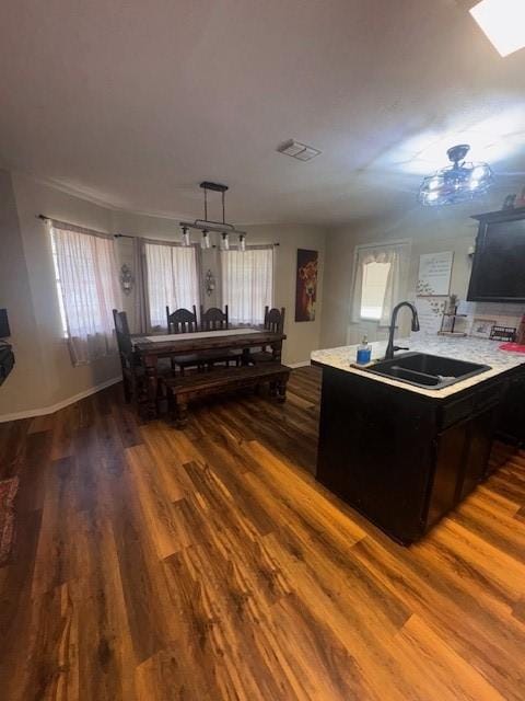 226 Colonial Cir, Athens, TX 75751 - kitchen with a sink, dark wood-style flooring, light countertops, and a skylight