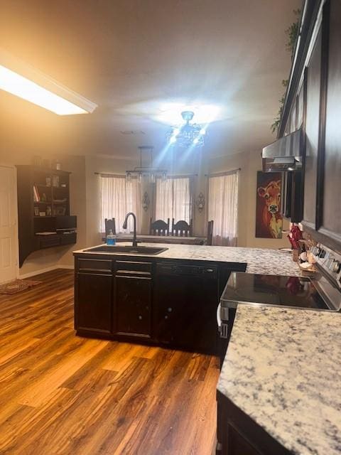 226 Colonial Cir, Athens, TX 75751 - kitchen featuring a sink, dishwasher, wood finished floors, a peninsula, and light countertops