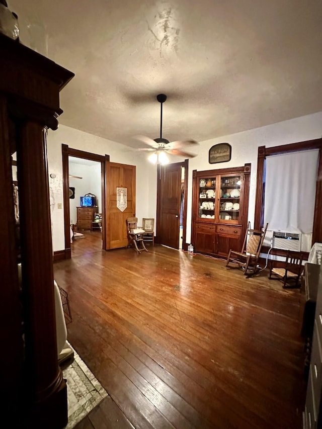 618 W Chestnut St, Denison, TX 75020 - living area with ceiling fan, dark wood-type flooring, and baseboards