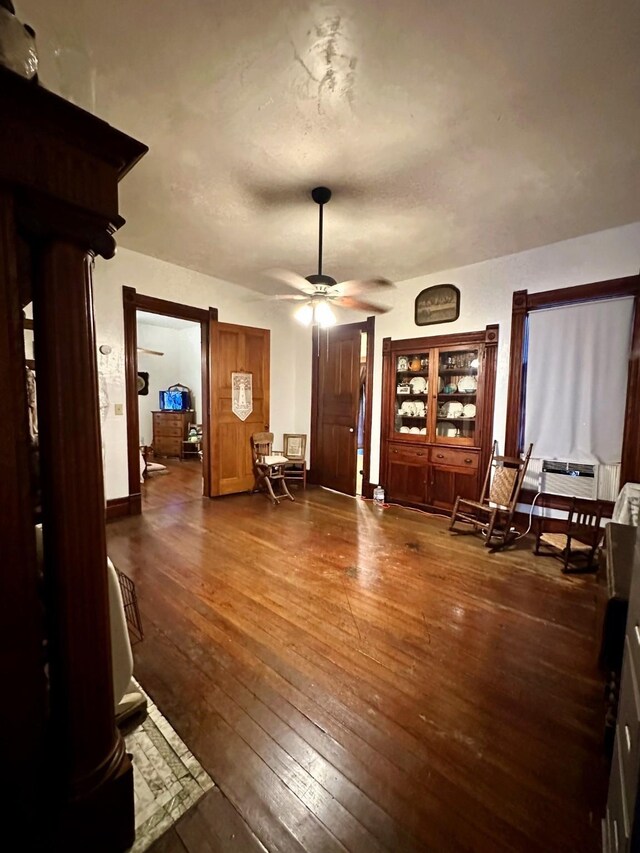 618 W Chestnut St, Denison, TX 75020 - living room with a ceiling fan, dark wood-type flooring, and baseboards