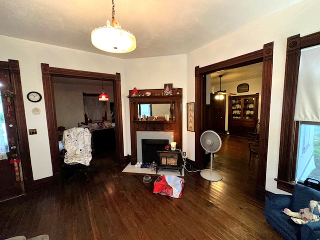 618 W Chestnut St, Denison, TX 75020 - living area with hardwood / wood-style floors, baseboards, and a fireplace with flush hearth