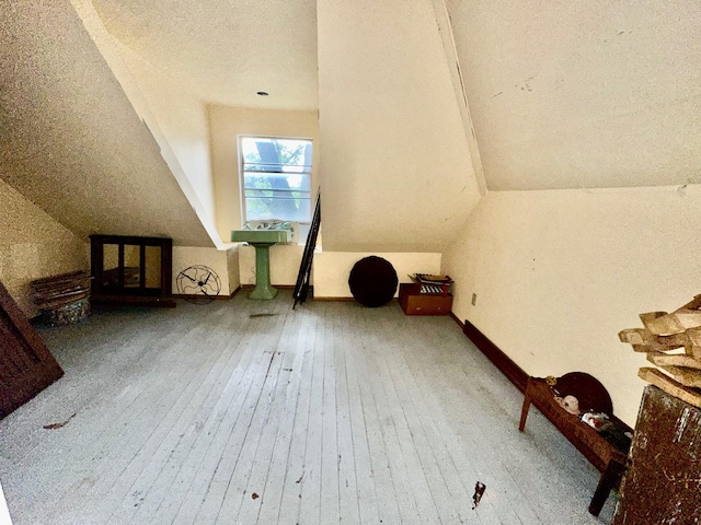 618 W Chestnut St, Denison, TX 75020 - additional living space with lofted ceiling, hardwood / wood-style flooring, and a textured ceiling