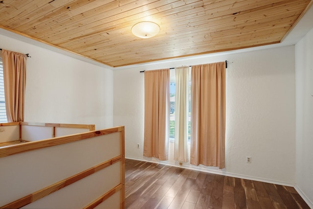 1807 Roosevelt Ct, Pantego, TX 76013 - unfurnished room with wood ceiling, dark wood finished floors, and baseboards