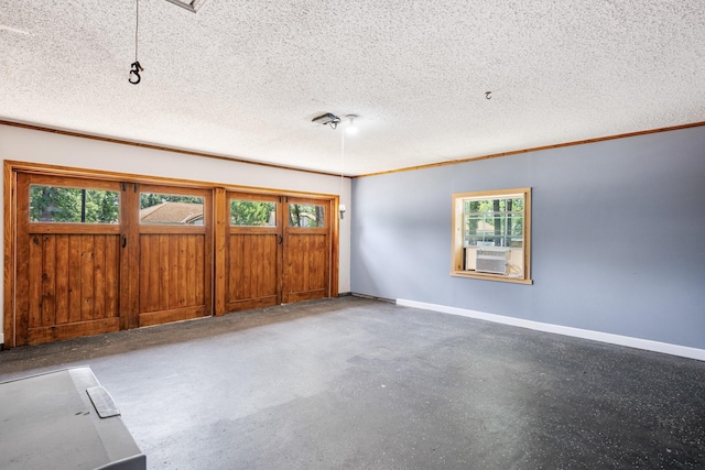 1807 Roosevelt Ct, Pantego, TX 76013 - empty room with plenty of natural light, baseboards, a textured ceiling, ornamental molding, and concrete flooring