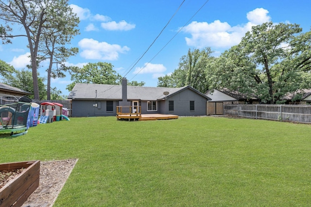 1807 Roosevelt Ct, Pantego, TX 76013 - back of house with a wooden deck and a trampoline