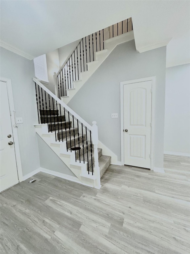 2324 Homewood Ln, Grand Prairie, TX 75050 - stairway featuring wood finished floors, crown molding, and baseboards