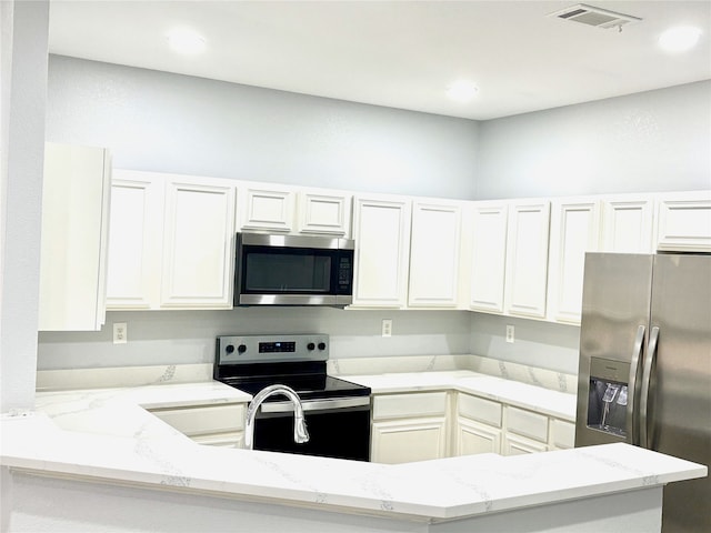 2324 Homewood Ln, Grand Prairie, TX 75050 - kitchen featuring stainless steel appliances, light stone counters, white cabinets, and recessed lighting