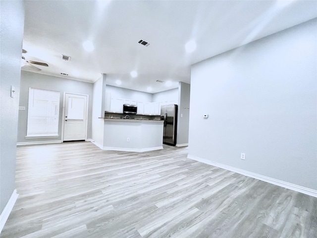 2324 Homewood Ln, Grand Prairie, TX 75050 - unfurnished living room featuring baseboards, a ceiling fan, and light wood-style floors