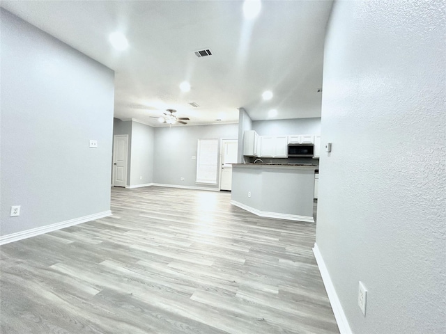 2324 Homewood Ln, Grand Prairie, TX 75050 - unfurnished living room featuring baseboards, light wood-type flooring, a ceiling fan, recessed lighting, and a textured wall