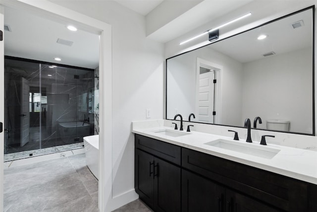 1309 Northpark Dr, Richardson, TX 75081 - bathroom with double vanity, a freestanding bath, a stall shower, recessed lighting, and toilet