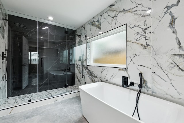 1309 Northpark Dr, Richardson, TX 75081 - bathroom featuring a marble finish shower, a soaking tub, marble finish flooring, recessed lighting, and tile walls