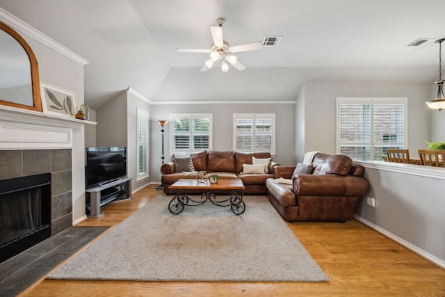 7308 Claridge Ln, Mckinney, TX 75072 - living room with lofted ceiling, ceiling fan, wood finished floors, a tiled fireplace, and baseboards