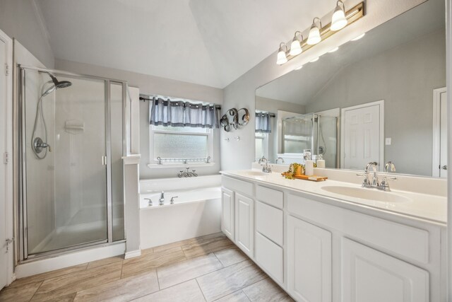 7308 Claridge Ln, Mckinney, TX 75072 - bathroom with a garden tub, double vanity, a shower stall, and vaulted ceiling