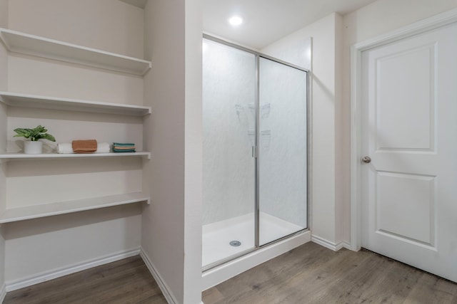 6514 Whitecap Dr, Princeton, TX 75407 - bathroom with wood finished floors, a stall shower, and baseboards
