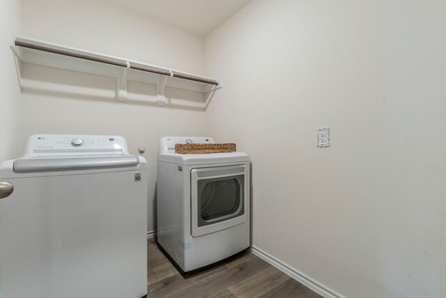 6514 Whitecap Dr, Princeton, TX 75407 - laundry room featuring washing machine and clothes dryer, wood finished floors, and baseboards