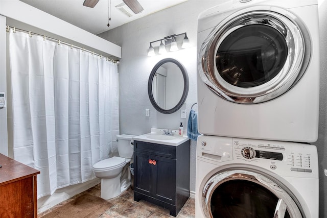 6811 Pecan St, Frisco, TX 75034 - washroom featuring stacked washer / drying machine, ceiling fan, a textured wall, and light stone finish flooring