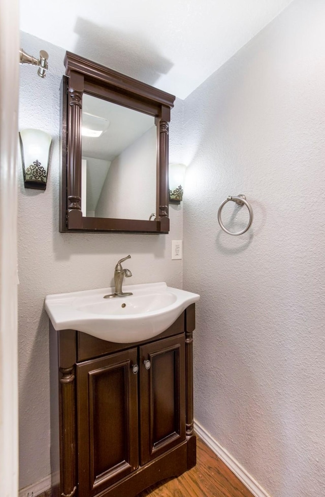 6811 Pecan St, Frisco, TX 75034 - bathroom with vanity, wood finished floors, and baseboards