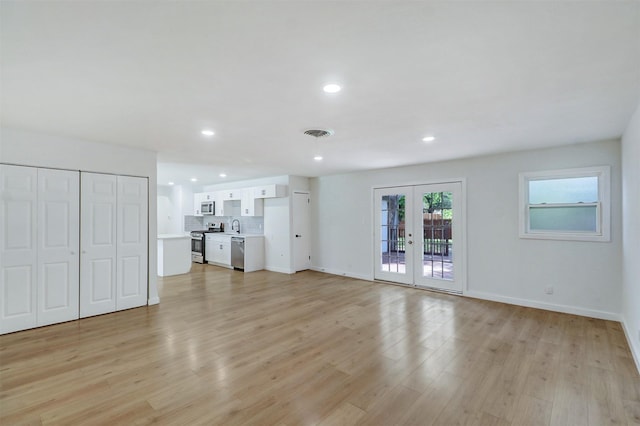 3524 Bahamas Dr, Mesquite, TX 75150 - unfurnished living room with light wood finished floors, recessed lighting, baseboards, and french doors