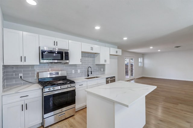 3524 Bahamas Dr, Mesquite, TX 75150 - kitchen with appliances with stainless steel finishes, a sink, a center island, tasteful backsplash, and recessed lighting