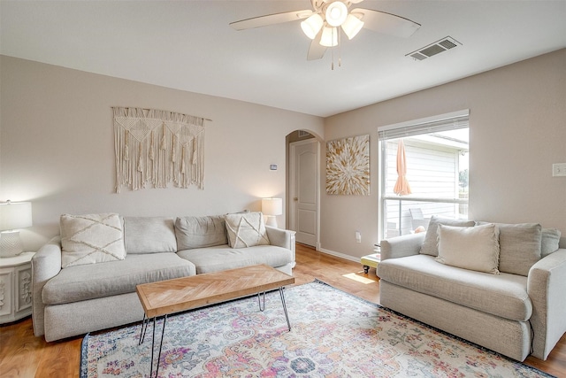 412 Hanover St, Burleson, TX 76028 - living area with arched walkways, ceiling fan, light wood-type flooring, and baseboards