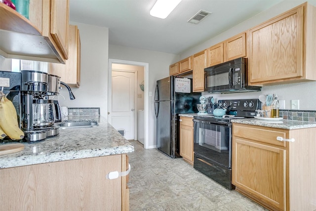 412 Hanover St, Burleson, TX 76028 - kitchen featuring black appliances, light brown cabinetry, a sink, light stone counters, and light floors