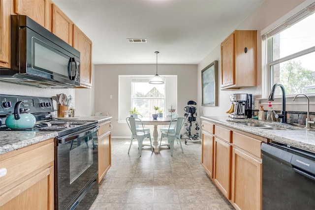 412 Hanover St, Burleson, TX 76028 - kitchen with black appliances, a sink, healthy amount of natural light, and light stone counters