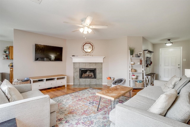 412 Hanover St, Burleson, TX 76028 - living room with a ceiling fan, wood finished floors, a tile fireplace, and baseboards