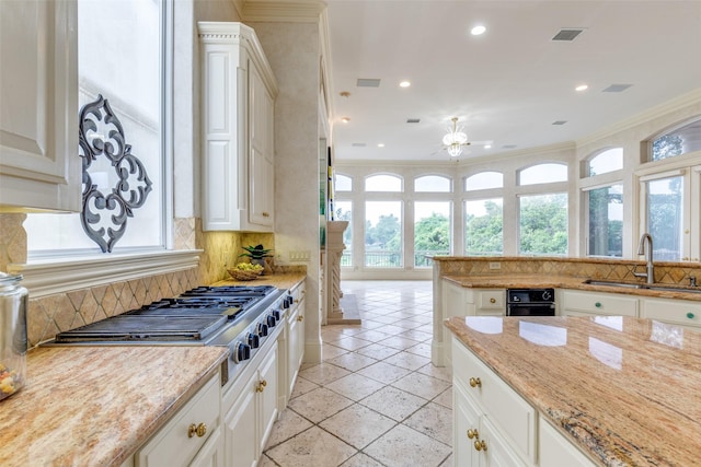 5528 Gleneagles Dr, Plano, TX 75093 - kitchen with a sink, healthy amount of natural light, tasteful backsplash, stainless steel gas cooktop, and recessed lighting