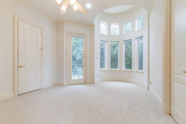 5528 Gleneagles Dr, Plano, TX 75093 - spare room featuring light colored carpet, ceiling fan, crown molding, arched walkways, and baseboards