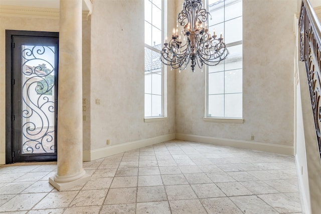 5528 Gleneagles Dr, Plano, TX 75093 - entrance foyer with baseboards, decorative columns, a chandelier, stone tile flooring, and a towering ceiling