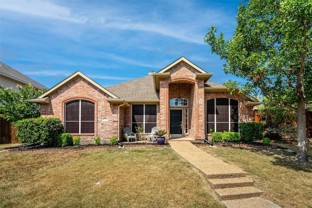 5409 Highlands Dr, Mckinney, TX 75070 - view of front facade featuring brick siding, a front lawn, and roof with shingles