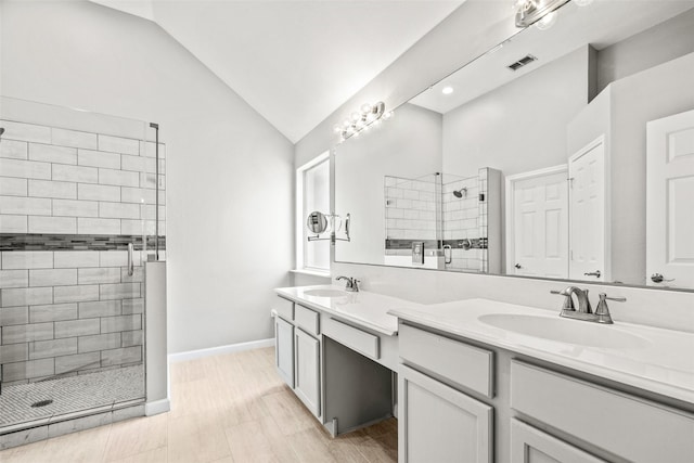 5409 Highlands Dr, Mckinney, TX 75070 - full bathroom with a tile shower, double vanity, lofted ceiling, and baseboards