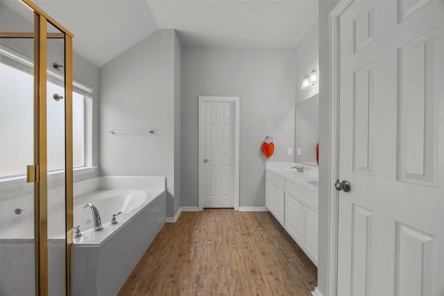 60 Misty Mesa Trl, Mansfield, TX 76063 - bathroom with vanity, a bath, wood finished floors, lofted ceiling, and baseboards