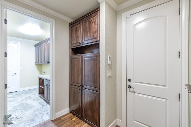 2326 Innisbrook Dr, Abilene, TX 79606 - laundry room with crown molding, cabinet space, baseboards, and electric dryer hookup