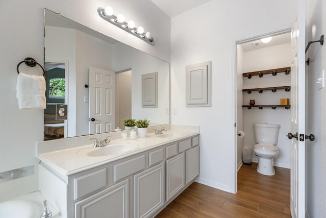 142 Shelby Trce, Murphy, TX 75094 - full bath featuring wood finished floors, double vanity, toilet, and baseboards