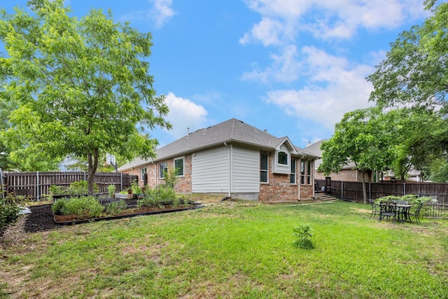 142 Shelby Trce, Murphy, TX 75094 - rear view of property featuring a garden and brick siding