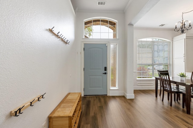 142 Shelby Trce, Murphy, TX 75094 - foyer entrance featuring ornamental molding, a chandelier, dark wood-style flooring, plenty of natural light, and baseboards